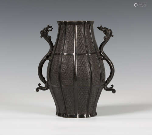 A Japanese brown patinated bronze vase, 19th century, the swollen body cast in low relief with