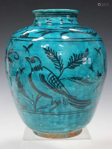 A Persian turquoise glazed earthenware vase, 19th century, the ovoid body painted in black with a