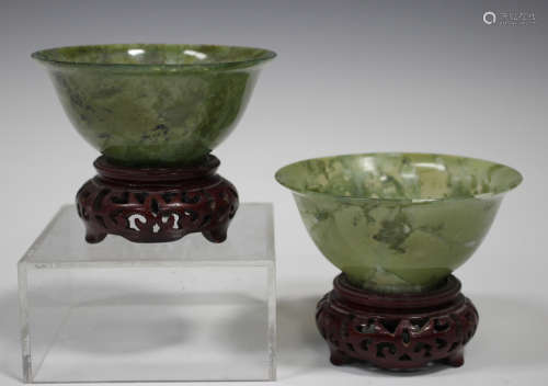 A pair of Chinese jade bowls, 20th century, of flared circular form, the stone of semi-translucent