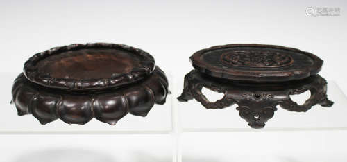 A Chinese hardwood stand, late Qing dynasty, the oval top with finely carved and pierced central