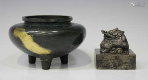 A Chinese silvered bronze seal, the square base surmounted with a dragon, cast six character