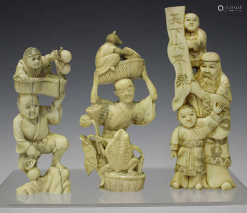 A Japanese carved ivory okimono figure, Meiji period, modelled as a man, toad and a cat, height