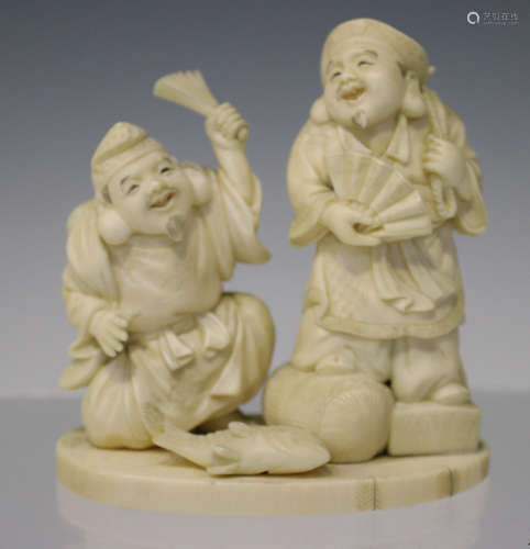 A Japanese carved ivory okimono figure group, Meiji/Taisho period, modelled as Ebisu and Daikoku, on