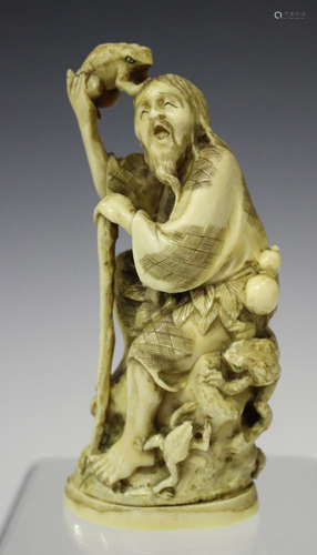 A Japanese carved and stained ivory okimono figure of Gama Sennin, Meiji period, the toad immortal