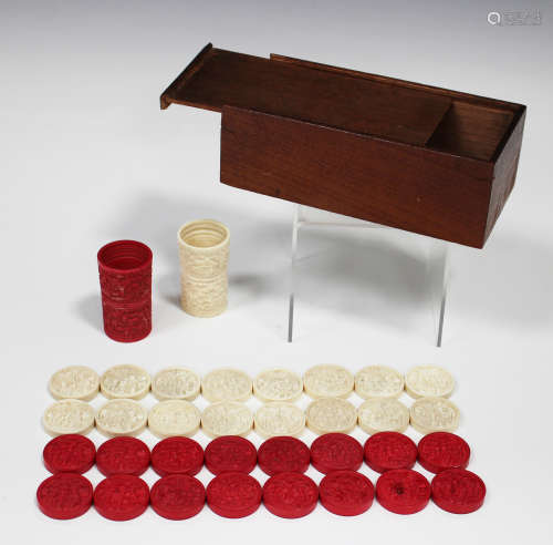 A set of thirty-two Chinese Canton export ivory backgammon chequers and a pair of dice shakers,