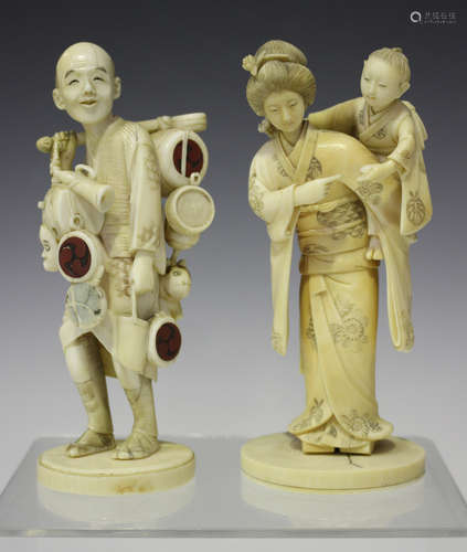 A Japanese carved ivory okimono figure group of a mother and child, Meiji period, modelled with