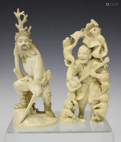 A Japanese carved ivory okimono figure of a bearded huntsman, Meiji period, modelled standing beside