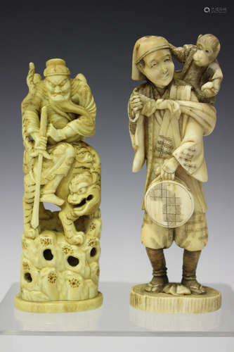 A Japanese carved and stained ivory okimono figure group, Meiji period, modelled as a warrior seated