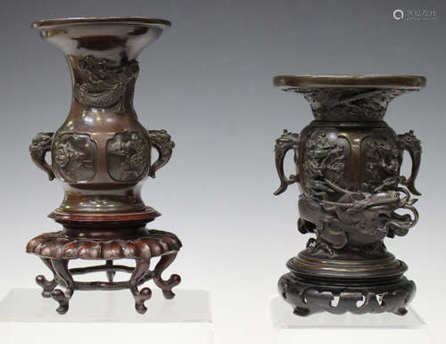 A Japanese brown patinated bronze vase, Meiji period, the body cast in high relief with panels of