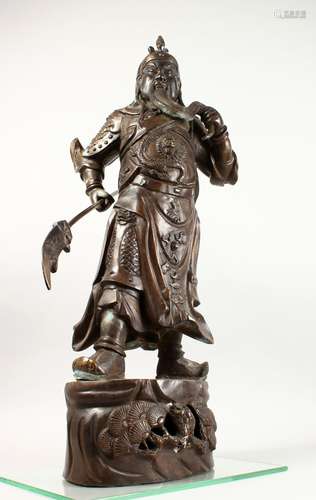 A GOOD 19TH CENTURY CHINESE BRONZE FIGURE OF A WARRIOR, the warrior stood upon a stylized foliage