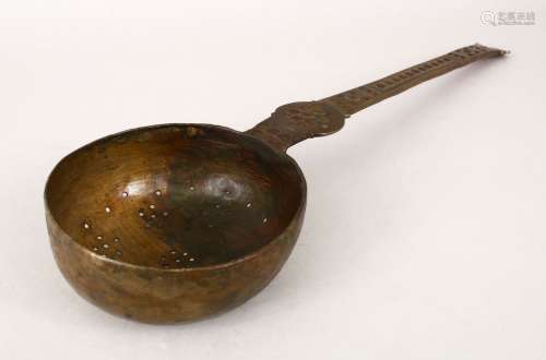 A LARGE BATAVIAN BRONZE STRAINER/LADLE with engraved decoration to the arm, 40.5cm long, the bowl