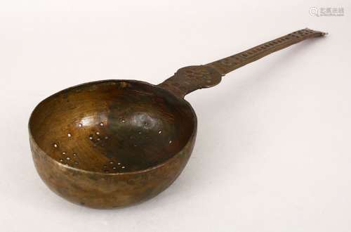 A LARGE BATAVIAN BRONZE STRAINER/LADLE with engraved decoration to the arm, 40.5cm long, the bowl