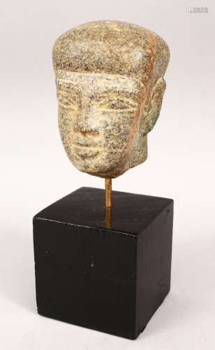 AN EGYPTIAN CARVED HARDSTONE HEAD on a wooden base, 25cm high on stand, stone head 12cm high.