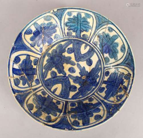 A 17TH/18TH CENTURY ISLAMIC BLUE AND WHITE POTTERY DISH with stylised floral decoration, 32.5cm