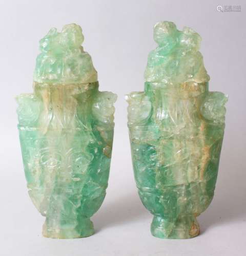 A GOOD PAIR OF CHINESE CARVED JADE LIDDED URNS, carved in archaic style with scrolling foliage
