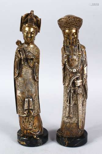A PAIR OF 19TH / 20TH CENTURY GILT WHITE METAL FIGURES OF EMPEROR AND EMPRESS, both depicted weating