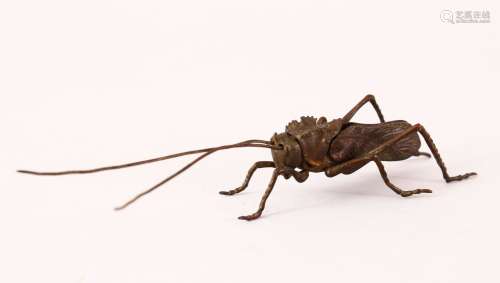 A JAPANESE BRONZE FIGURE OF A GRASSHOPPER, the underside with a gilt signature. 12cm long.