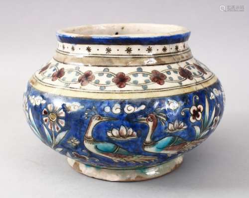 A 19TH CENTURY PERSIAN QAJAR GLAZED POTTERY VASE, decorated with a blue ground and native floral