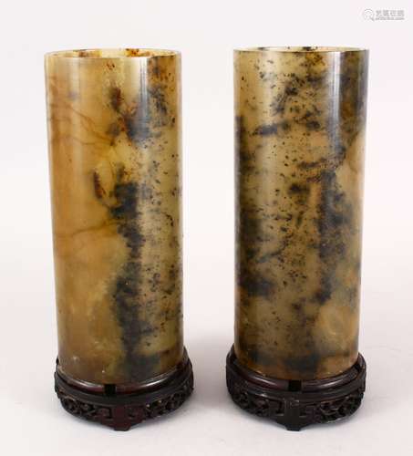 A PAIR OF 19TH / 20TH CENTURY CHINESE CARVED JADE CYLINDRICAL VASES, mounted to hardwood stands,