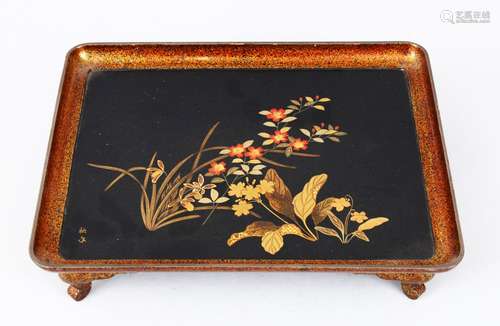 A GOOD JAPANESE MEIJI PERIOD LACQUER TRAY ON FEET, the tray decorated with scenes of native flora,