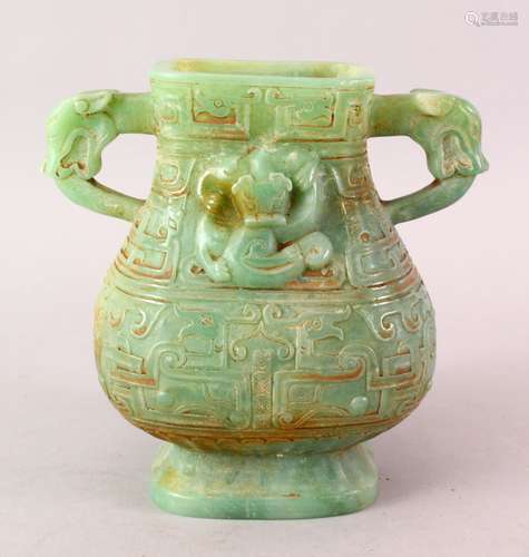 A CHINESE CARVED JADE LIKE HARD STONE TWIN HANDLE ARCHAIC STYLE VASE, carved in archaic style with