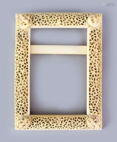 A GOOD 19TH CENTURY BURMESE CARVED IVORY PHOTO FRAME, carved in openwork to depict scroll, each