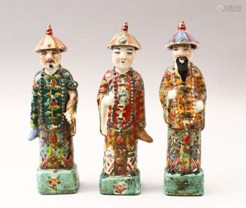 THREE 19TH / 20TH CENTURY CHINESE FAMILLE VERTE PORCELAIN FIGURES, each wearing hats with bead