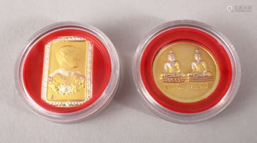 TWO GOOD THAI / TIBETAN GILT METAL COINS / TABLETS, both decorated with calligraphy with scenes of