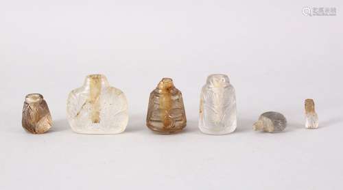 A COLLECTION OF FOUR 19TH CENTURY MUGHUAL INDIAN CARVED ROCK CRYSTAL PERFUME BOTTLES, each with leaf