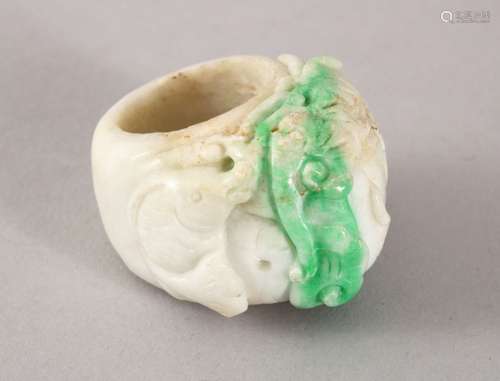 A 20TH CENTURY CHINESE CARVED JADEITE RING, the ring carved with fish amongst lotus, 4cm, internal