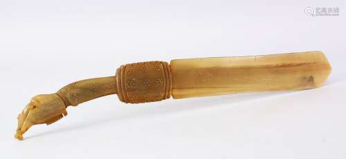 A 19TH CENTURY INDIAN CARVED RHINO HORN PAGE TURNER, crved with a fish handle and metal stud