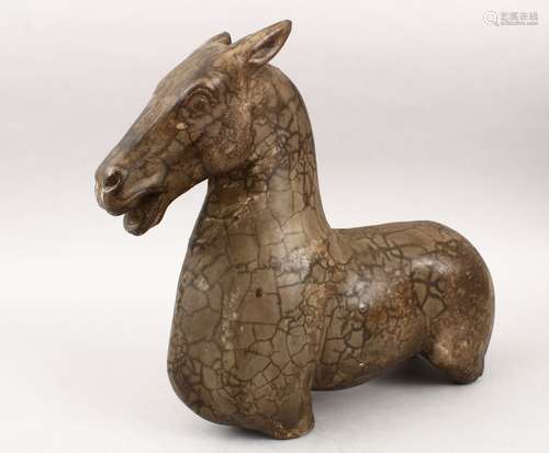 A GOOD POSSIBLY TANG DYNASTY CARVED POTTERY MODEL OF A HORSE BUST, with its head aloft and its mouth