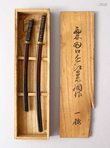 A GOOD BOXED PAIR OF JAPANESE MEIJI PERIOD MINIATURE SWORDS, in original signed tomobako, 21cm &