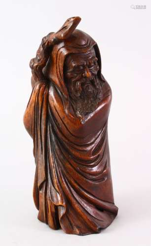 A GOOD CHINESE BAMBOO CARVED FIGURE OF SHOU LAO, carved holding his staff in traditional attire,