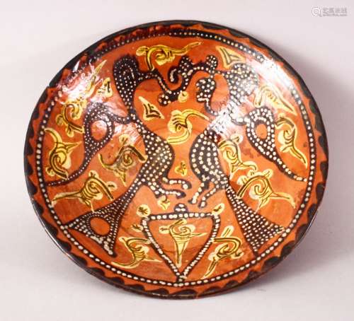 A GOOD IRANIAN NISHABOUR POTTERY BOWL, a red ground decorated with scenes of birds, 22.5cm