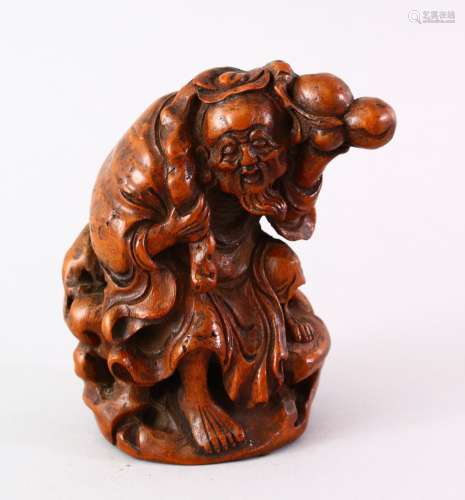 A 19TH CENTURY CHINESE CARVED BAMBOO FIURE OF AN IMMORTAL, modeled holding the branches of peach