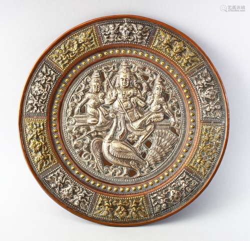 AN INDIAN TANJORE SILVER OVERLAID DISH, the central panel depicting three figures and a bird, the