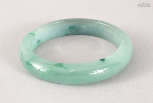 A GOOD 19TH / 20TH CENTURY CHINESE CARVED JADEITE BANGLE, 7cm & internal 5cm.