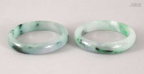 TWO 19TH / 20TH CENTURY CHINESE CARVED JADEITE BANGLES, 7.4cm diameter, internal 5.5cm.