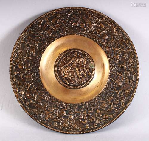 A 19TH CENTURY INDAIN BRASS CHARGER / DISH, with embossed decoration depicting figure on