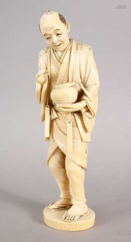 A GOOD JAPANESE MEIJI PERIOD CARVED IVORY OKIMONO - LANTERN LIGHTER, the man stod holding his