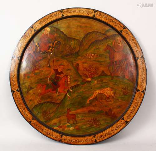 A GOOD 19TH CENTURY PERSIAN PAPIER MACHE PAINTED ROUND PANEL, with calligraphy reading 