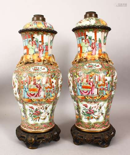 A PAIR OF CHINESE 19TH CENTURY CANTON PORCELAIN VASES / LAMPS, with panel decoration of figures,