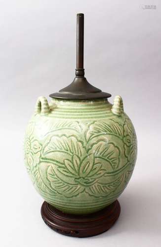 A 19TH CENTURY OR EARLIER CHINESE CARVED CELADON TRIPLE HANDLE PORCELAIN VASE / LAMP, the body of