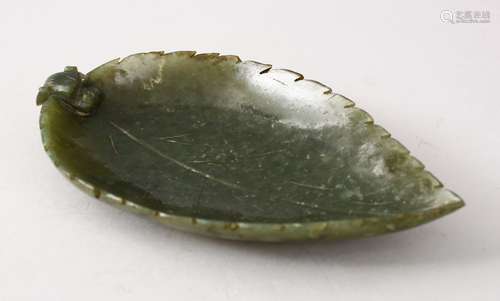 AN EARLY 20TH CENTURY CHINESE CARVED JADE BRUSH WASHER IN THE FORM OF A LEAF, with a lion dog head