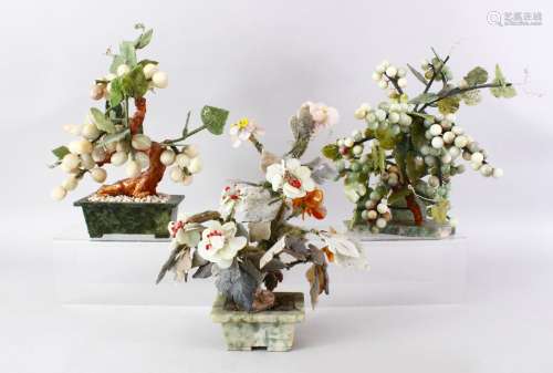 THREE GOOD 19TH / 20TH CENTURY CHINESE CARVED JADE TREE FIGURES, one of a spray of grapevine and