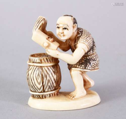 A JAPANESE MEIJI PERIOD CARVED AND STAINED IVORY OKIMONO - BARREL MAKER, the figure carved to depict