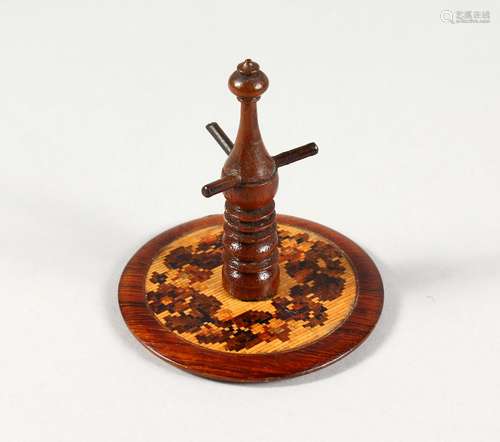 A TUNBRIDGE WARE CIRCULAR RING STAND, with circular base. 3.25ins high.