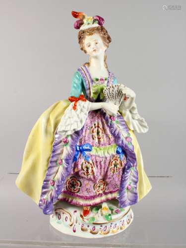A CONTINENTAL PORCELAIN FIGURE OF A LADY, carrying a fan. 10ins high.
