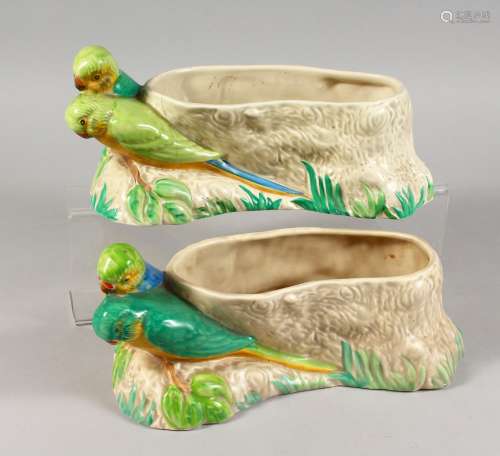 CLARICE CLIFF, A PAIR OF BUDGERIGAR POTTERY PLANTERS, moulded as a pair of birds next to a tree